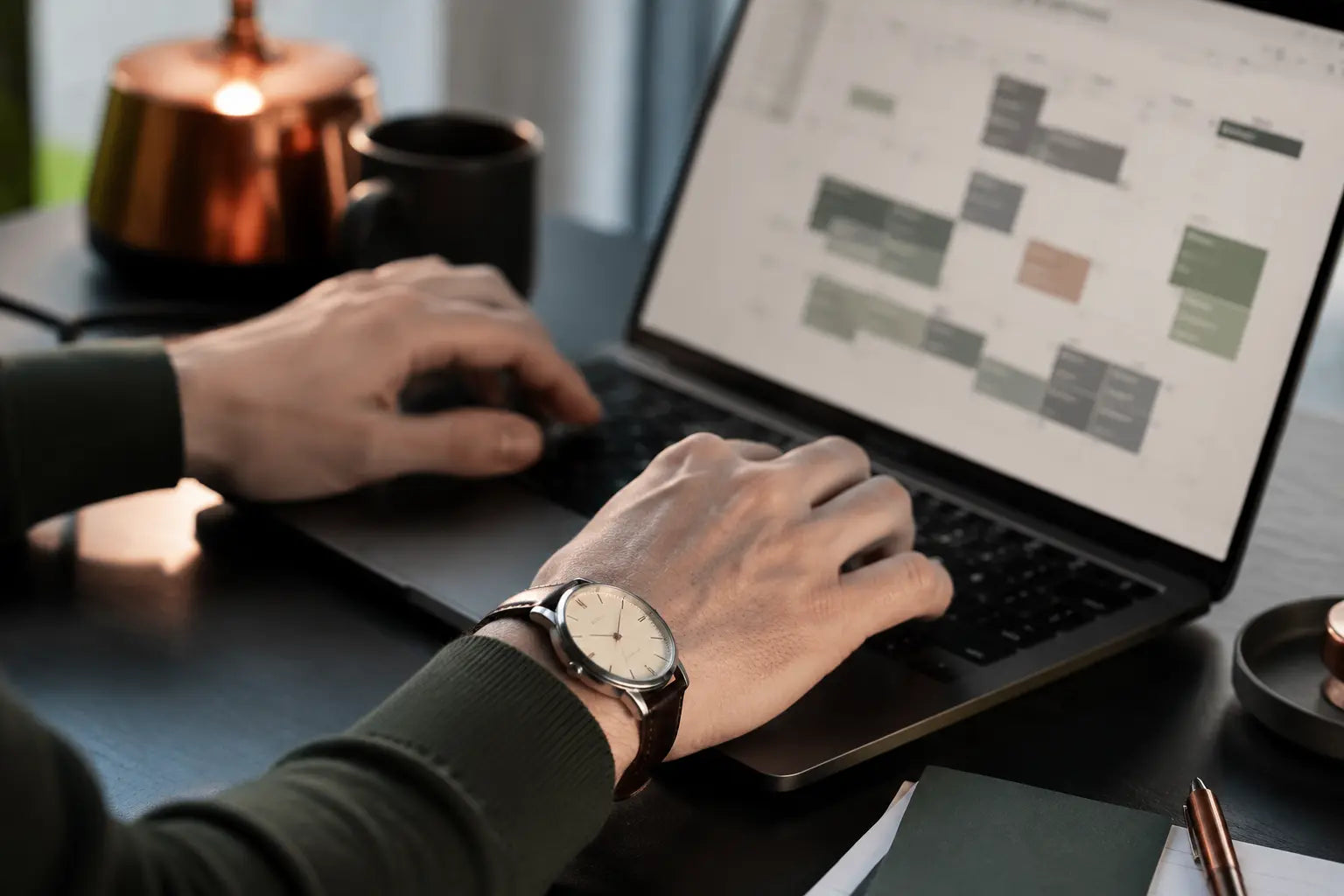 A professional organizing a digital calendar while working at a laptop